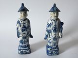 pair of blue and white porcelain figurines of a man and a woman