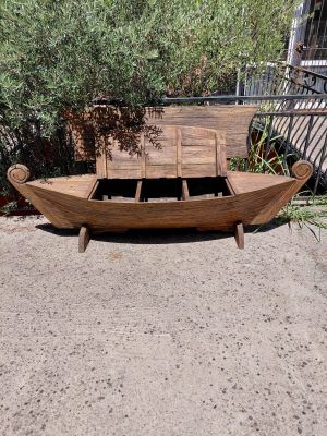 a wooden boat that is sitting on the ground