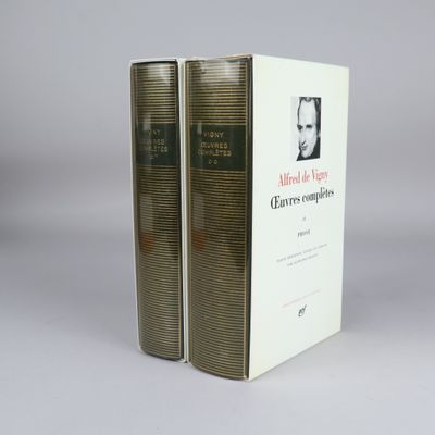 two books sitting on top of each other on a white surface