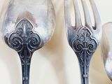 three spoons and a fork on a table