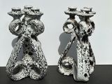 two vases that are sitting on a table