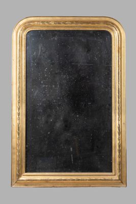 an antique gold framed mirror with a black background