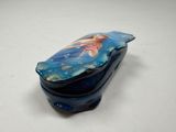a small blue box with a picture of a mermaid on it