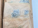 many different stamps on a piece of paper hanging on a wall