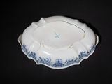 a blue and white bowl with a cross on it