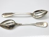 two spoons that are sitting next to each other