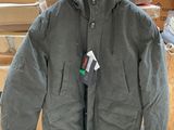 a coat hanging on a clothes rack in a store