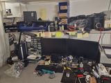 a desk with a lot of clutter on top of it