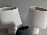 two vases that are next to each other on a table