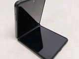 a close up of the back of a black phone with its lid open