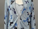 an image of a mannequin wearing a blue and black floral cardigan