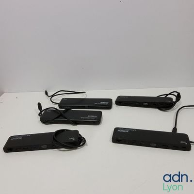 four black electronic devices sitting on top of a white table