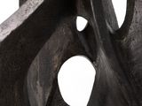 sculpture of a black sculpture with holes in the middle of it
