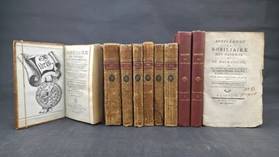 several old books sitting on top of each other on a table