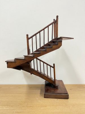 an image of a wooden staircase with a handrail on top of it