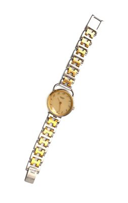 HERMÈS Paris Montre bracelet de dame modèle "Arceau" en méta…