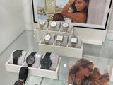 a lot of watches on display in a glass case