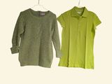two women ' s shirts hanging on a hanger on a white wall