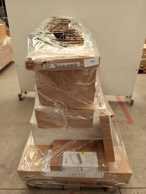a stack of boxes sitting on top of a cart in a warehouse