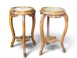 pair of carved wood side tables with marble tops