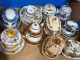 many different types of tea cups and saucers on the table