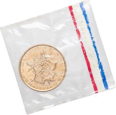 the coin is in a plastic bag with a red, white, and blue stripe