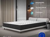 bed in a room with a wooden paneled wall, a white bed frame and a white headboard