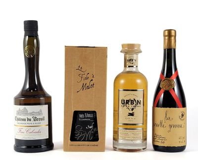 three bottles of wine and a box of liquor on a white surface