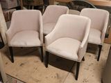 three white chairs sitting next to each other in a room