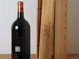 a bottle of wine sitting next to a box on a table