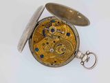 an image of a close up of a pocket watch on a white surface
