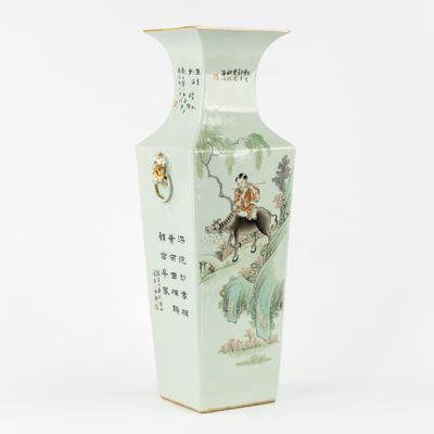 a vase with a painting of a man riding a horse on it