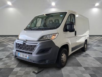 the white van is parked on a checkered floor in the garage
