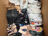 many pairs of shoes in a box on the floor
