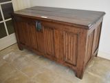 an image of a wooden chest in the corner of a room