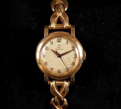 an image of a close up of a wrist watch on a black surface