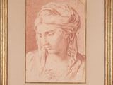 un dessin représentant la tête d'une femme dans un cadre doré