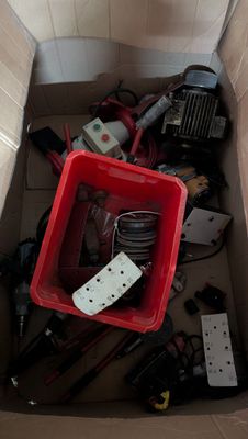 une boîte rouge remplie de matériel électrique dans une pièce