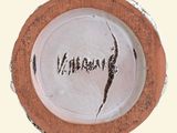 a white plate with a brown rim with a word on it