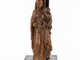 a wooden statue of a woman holding a child on a marble base