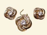 three pieces of jewelry are shown on a white surface