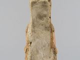 an old stone block with a small face on it