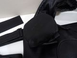 a black leather jacket and a black belt on a white table