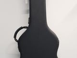 a black acoustic guitar case sitting on top of a blue floor