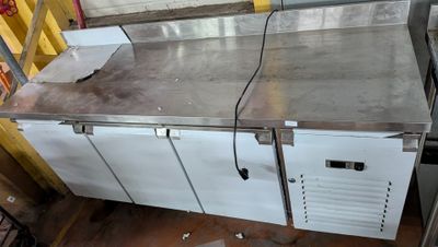 stainless steel counter top with two doors and a drawer underneath it