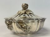 silver plated bowl with a lid and a spoon in the middle