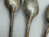three spoons that are sitting next to each other on a table