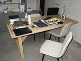 a wooden table with a laptop on top of it