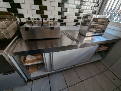 stainless steel counter top in a commercial kitchen with tiled backsplash