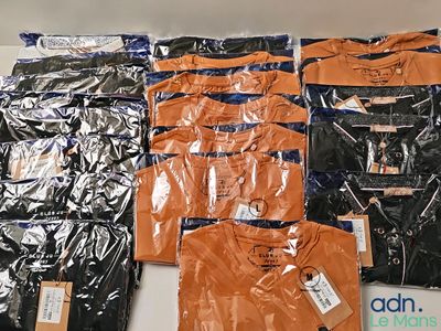 a lot of t - shirts that are on the table